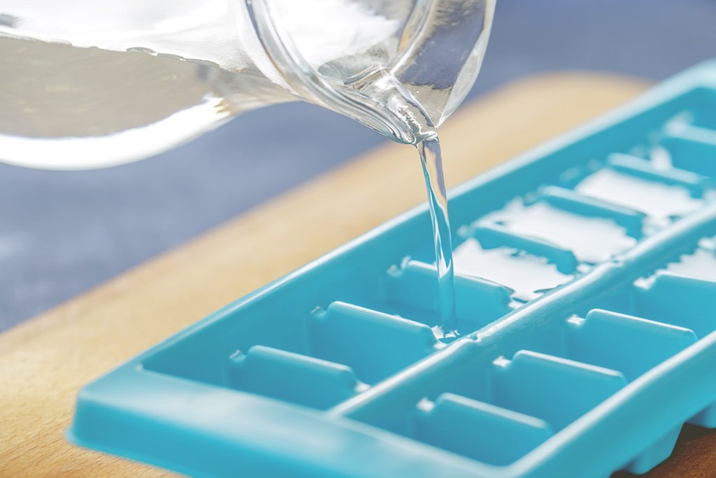 Pouring water into an ice cube tray